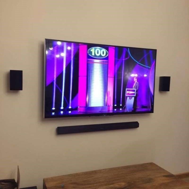 Wall mounted television with sound bar and concealed cabling